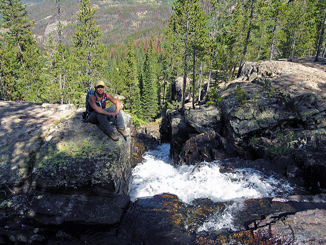 Suzy sitting at the top of Cascade Falls, Cascade Creek