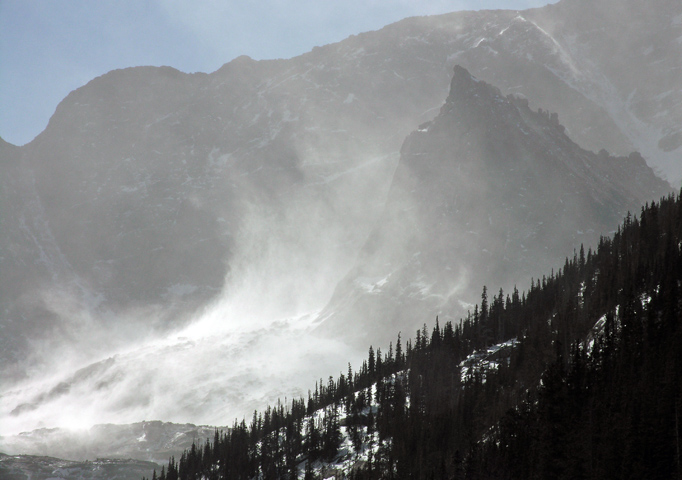 Plumes of blowing snow reaching hundreds of feet into the air next to Spearhead in the Glacier Gorge, Rocky Mountain National Park