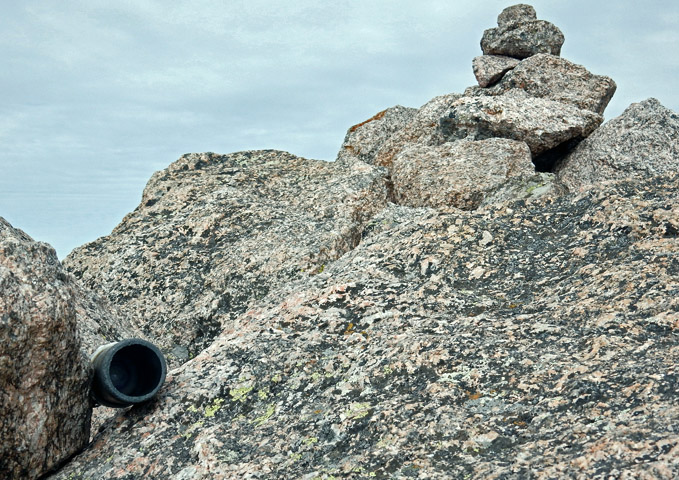 Photo of the summit register canister and the summit Cairn on Pagoda Mountain