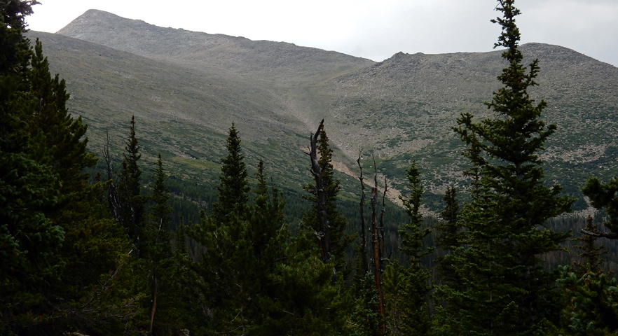 Afternoon gloomy drizzly view of Storm Peak and North Ridge from just below timberline on the North Longs Peak Trail