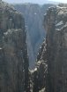 Looking through a narrow slit in a near wall at another, further back wall; Black Canyon of the Gunnison