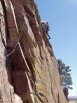 Leading through the 3rd pitch crux traverse on Ruper, Red Garden Wall, Eldorado Canyon, Boulder, Colorado