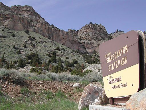 Entering Sinks Canyon State Park sign and the cave area, north main canyon wall