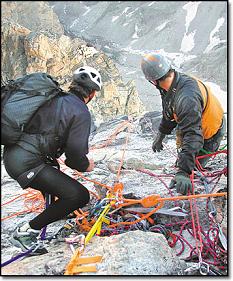 Photo by Leo Larson / National Park Service Park rangers Jack McConnell and Marty Vidak prepare to haul injured climber Rodrigro Liberal to a ledge Saturday on the Grand Teton at about 13,000 feet.
