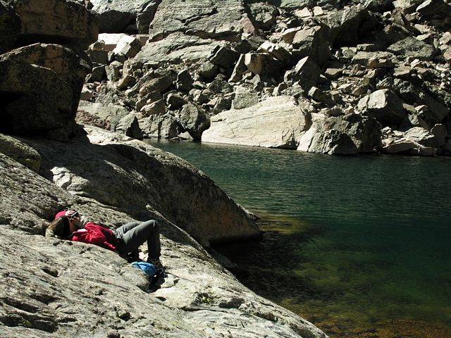 Suzy at Chasm Lake with binoculars, watching climbers on the Diamond Wall, Rocky Mountain National Park, Colorado