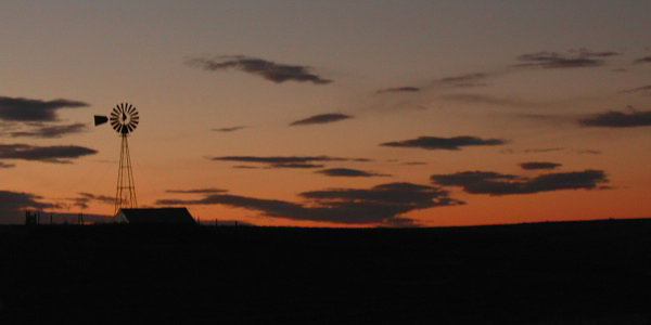 Dawn creeping up on a old wind mill along I25 in northern Colorado