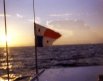 The Panamanian flag mounted on top of the charter boat heading out to the Perlas Islands, with the sunrise in the background