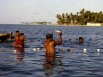 With fishing nets in-place and pulled in tight, the Kuna Indians would swim in the nets, grabbing fish, knocking them out on the net buoys, and then tossing them into the boats